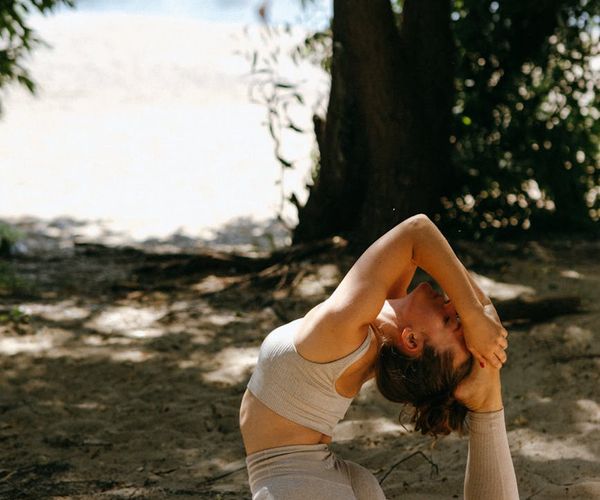 Person performing a serene yoga pose in nature