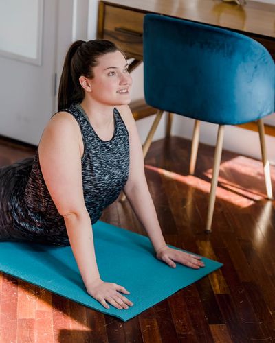 Person practicing gentle morning stretches in a bright room